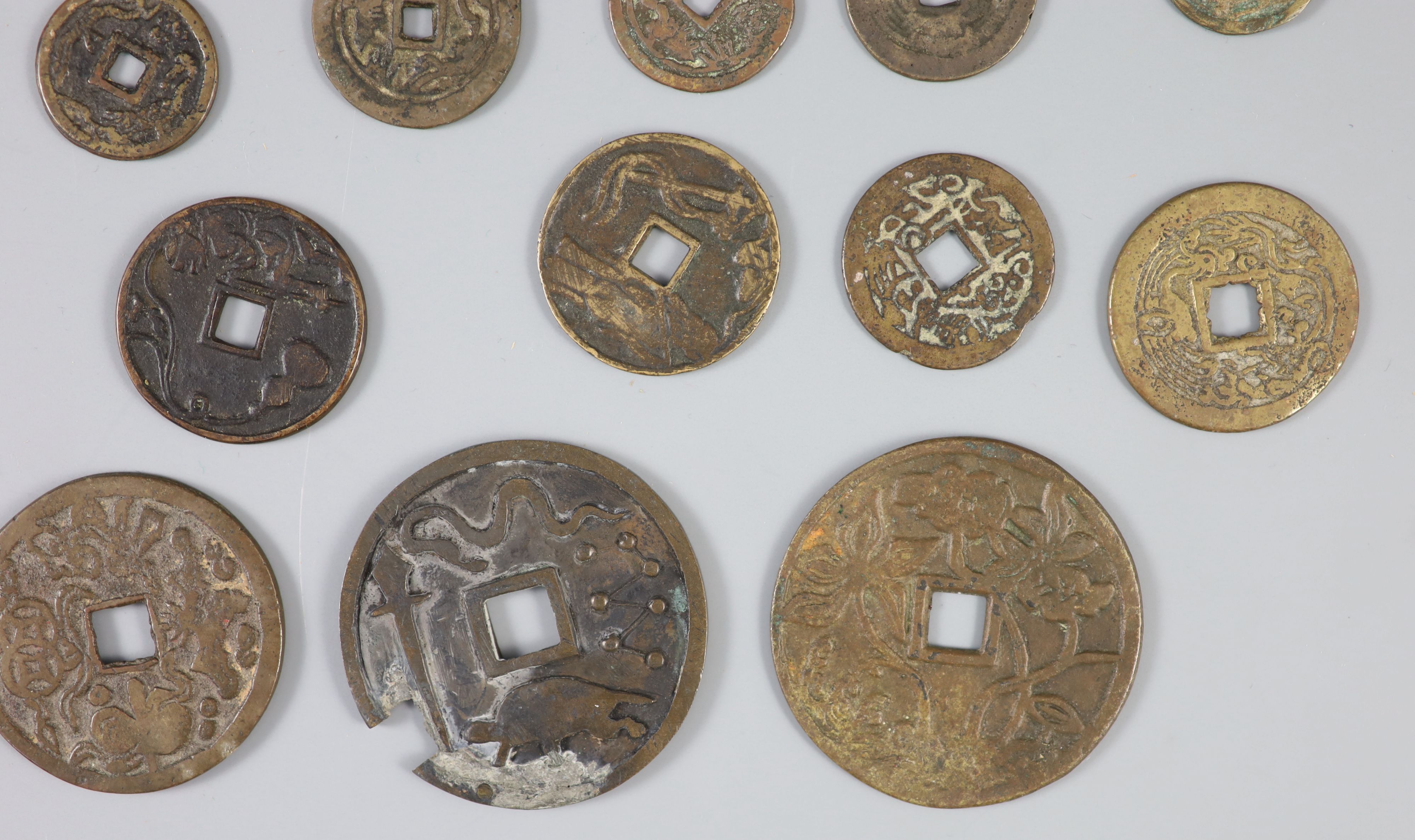 China, a group of 26 bronze or brass charms or amulets, Qing dynasty,